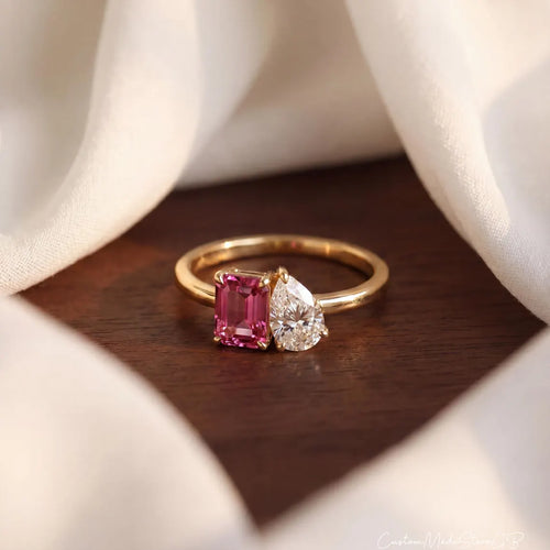 Gold Toi et Moi ring with a pink emerald-cut stone and a clear pear-cut stone